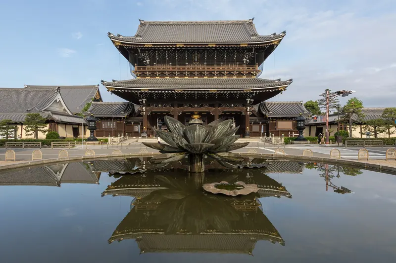 A Kyoto temple gate reflected in a still pond