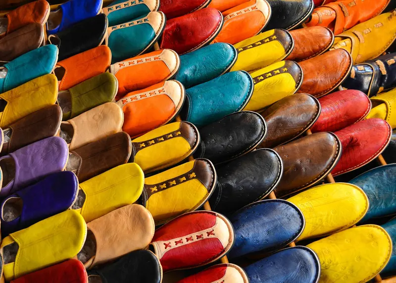 Stacks of brightly colored leather slippers in a Marrakech souk